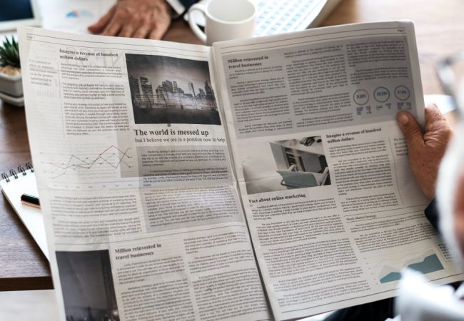 business-people-reading-newspaper-min